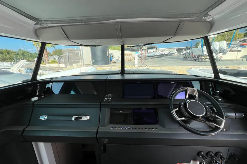  Yacht Photos Pics 2023 Axopar 45 Cross Cabine helm with modern dashboard and steering wheel.