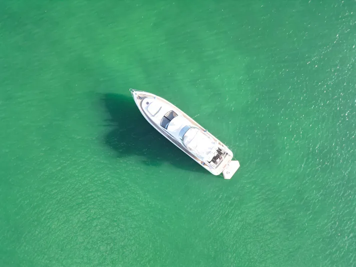 Finesse Yacht Photos Pics Aerial view of 2007 Azimut 68E yacht on clear green water.
