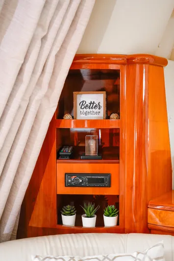 Finesse Yacht Photos Pics Interior of 2007 Azimut 68E yacht with wooden shelves and decor items.