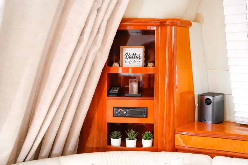 Finesse Yacht Photos Pics Luxurious interior of 2007 Azimut 68E yacht with elegant wooden shelving and decor.