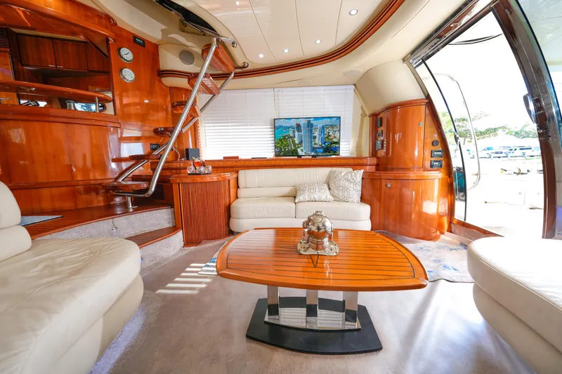 Finesse Yacht Photos Pics Luxurious interior of a 2007 Azimut 68E yacht with elegant wood finishes and plush seating.