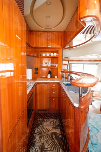 Finesse Yacht Photos Pics Luxurious 2007 Azimut 68E yacht kitchen with sleek wood cabinetry and modern appliances.