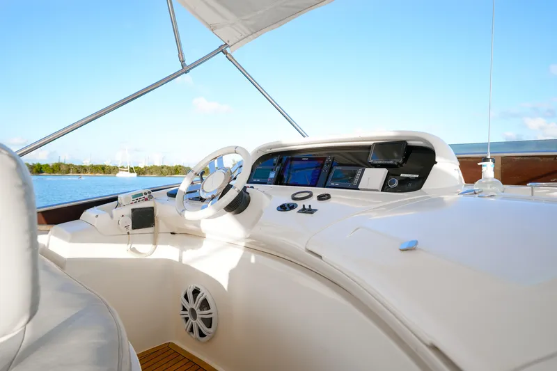 Finesse Yacht Photos Pics 2007 Azimut 68E yacht helm with modern navigation equipment and scenic water view.