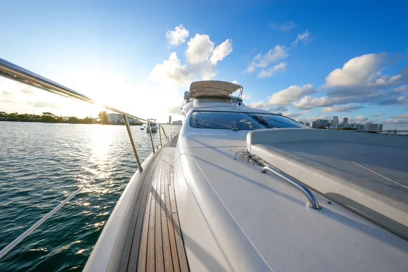 Finesse Yacht Photos Pics Azimut 68E yacht cruising on water at sunset, 2007 model.