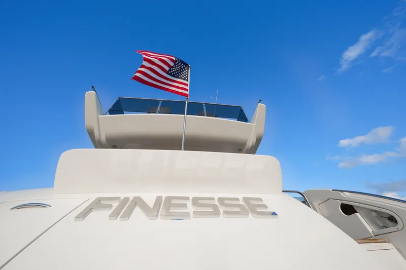 Finesse Yacht Photos Pics Azimut 68E 2007 yacht "Finesse" with American flag against blue sky.