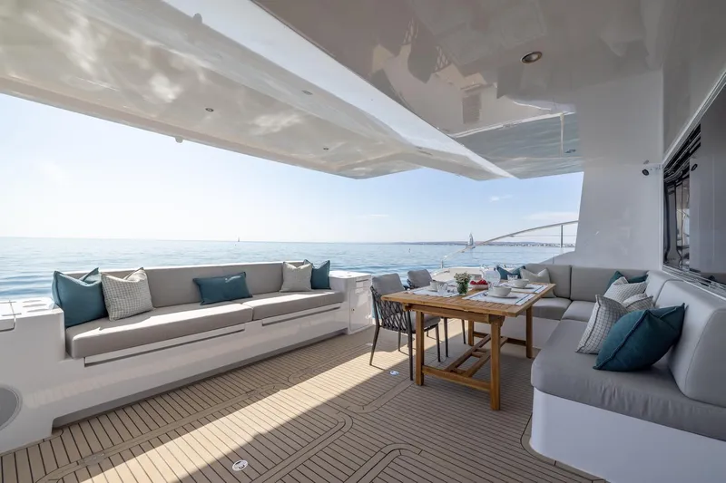  Yacht Photos Pics Spacious deck of the 2025 Silent 60 yacht with comfortable seating and dining area.