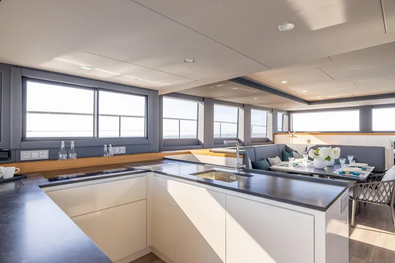  Yacht Photos Pics Modern kitchen and dining area on Silent 60 yacht, 2025 model.