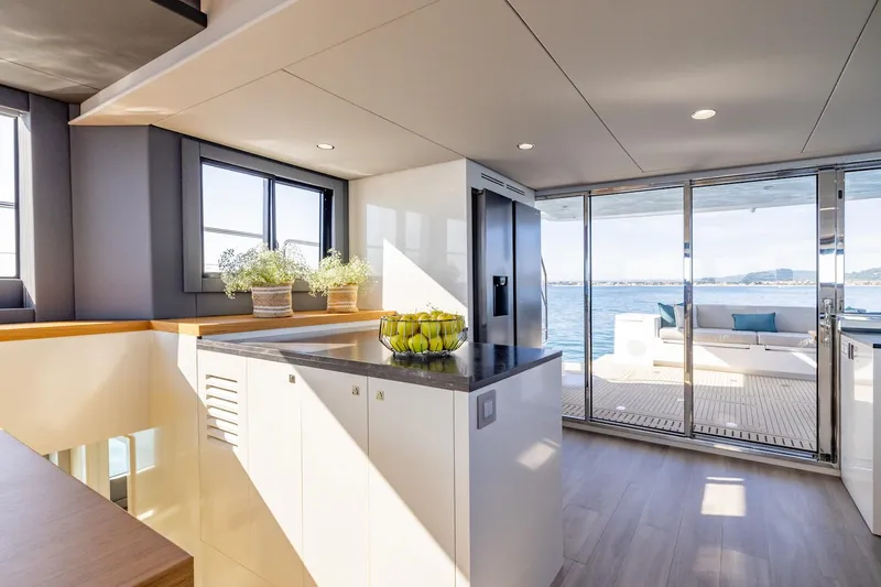  Yacht Photos Pics Modern kitchen and lounge area on Silent 60 yacht, 2025 model, with ocean view.