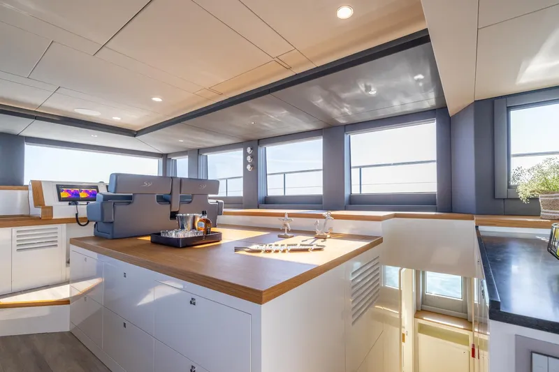  Yacht Photos Pics Modern kitchen interior on Silent 60 yacht, 2025 model, with sleek design and ample natural light.