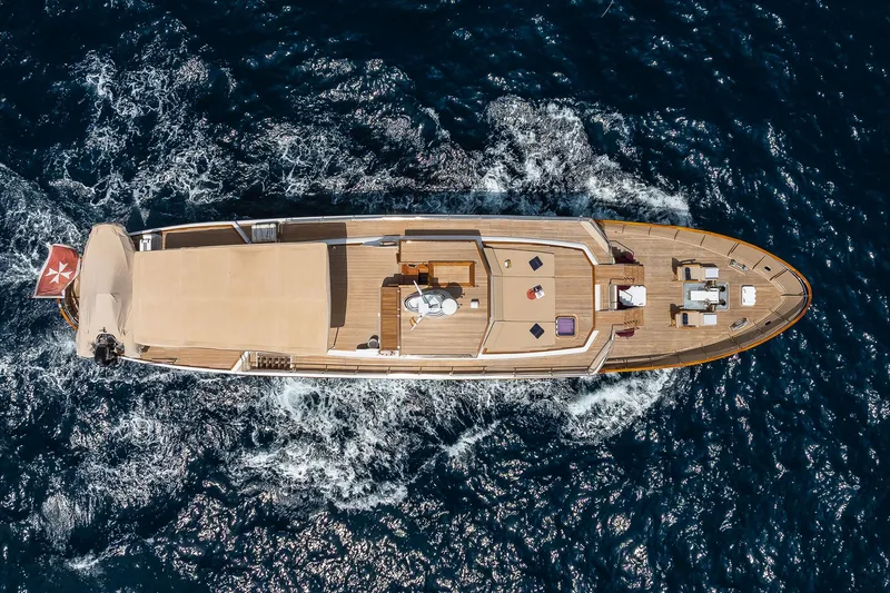 Black Pepper Yacht Photos Pics Aerial view of 1975 Lavagna round stern motoryacht cruising on open sea.