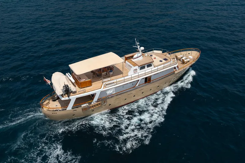 Black Pepper Yacht Photos Pics Aerial view of 1975 Lavagna round stern motoryacht cruising on open sea.