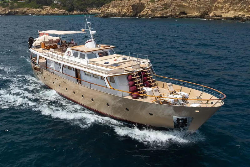 Black Pepper Yacht Photos Pics 1975 Lavagna round stern motoryacht cruising on blue ocean waters.