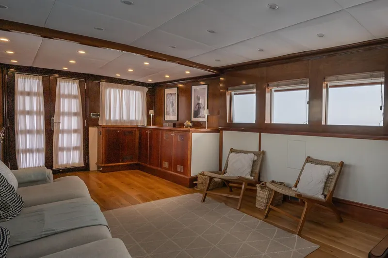 Black Pepper Yacht Photos Pics Luxurious 1975 Lavagna round stern motoryacht interior with elegant wood paneling and cozy seating.