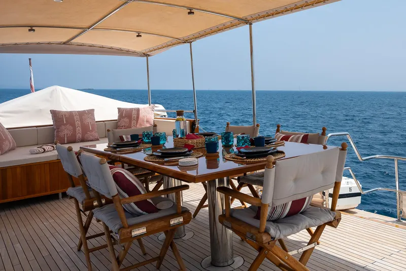 Black Pepper Yacht Photos Pics Luxurious dining setup on 1975 Lavagna round stern motoryacht, overlooking the ocean.