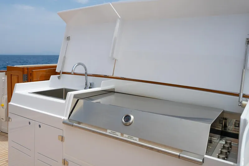 Black Pepper Yacht Photos Pics Outdoor kitchen on 1975 Lavagna round stern motoryacht, featuring sink and grill.