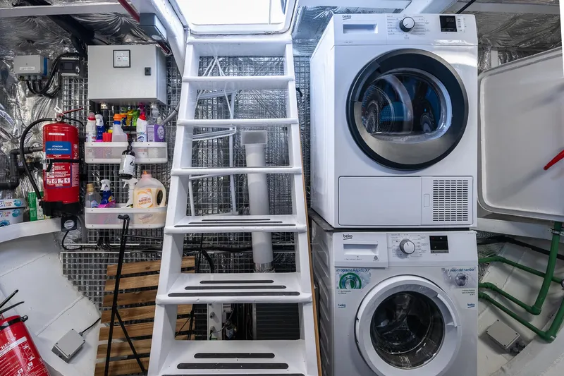 Black Pepper Yacht Photos Pics Laundry area on 1975 Lavagna round stern motoryacht with washer, dryer, and cleaning supplies.