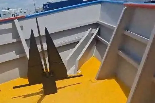  Yacht Photos Pics Custom built offshore crew vessel deck with anchor, 2009 model, featuring vibrant yellow flooring.