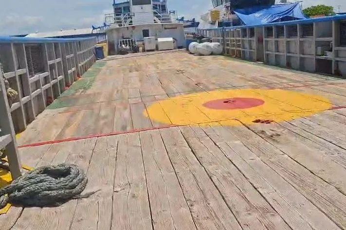  Yacht Photos Pics Custom built offshore crew vessel deck, 2009 model, with wooden planks and safety markings.