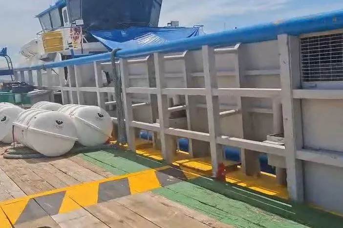  Yacht Photos Pics Custom-built offshore crew vessel deck with safety equipment, 2009 model, under clear skies.