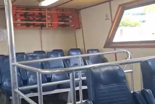  Yacht Photos Pics Interior of a 2009 custom-built offshore crew vessel with blue seating and safety equipment.