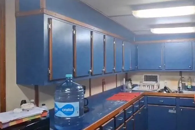  Yacht Photos Pics Interior of a 2009 custom-built offshore crew vessel kitchen with blue cabinets.