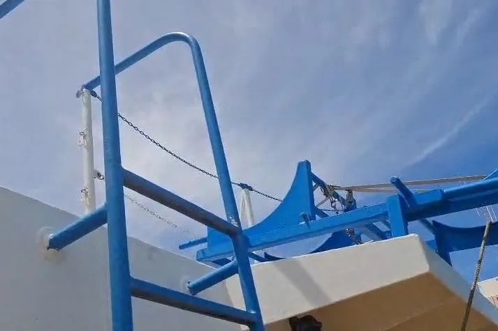  Yacht Photos Pics Blue railing on a 2009 custom-built offshore crew vessel under a clear sky.
