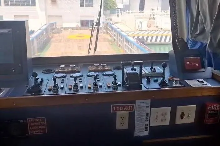  Yacht Photos Pics Control panel of a 2009 custom-built offshore crew vessel, featuring various levers and switches.