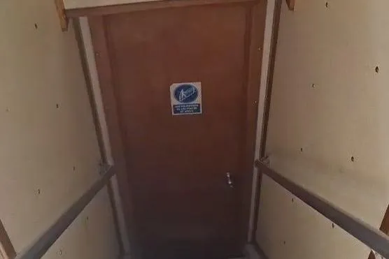  Yacht Photos Pics Stairway leading to a wooden door on a 2009 custom-built offshore crew vessel.