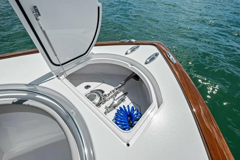 Galati Yacht Sales Trade Yacht Photos Pics 2025 Valhalla Boatworks V-37 anchor compartment with coiled blue hose, open hatch, and ocean backdrop.