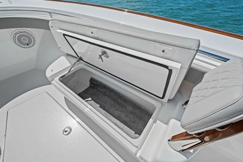 Galati Yacht Sales Trade Yacht Photos Pics 2025 Valhalla Boatworks V-37 storage compartment with cushioned seating and ocean backdrop.