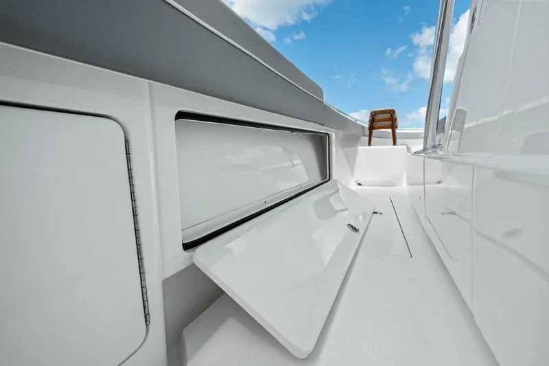 Galati Yacht Sales Trade Yacht Photos Pics 2025 Valhalla Boatworks V-37 interior with open storage compartment, sleek design, and clear blue sky.