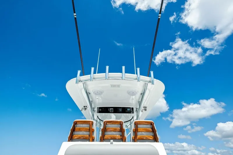 Galati Yacht Sales Trade Yacht Photos Pics 2025 Valhalla Boatworks V-37 helm against a bright blue sky with clouds.