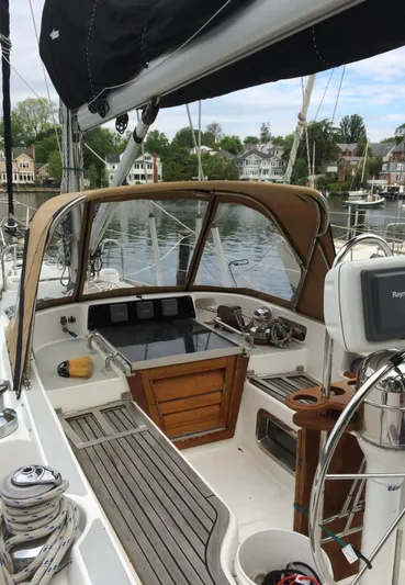 Dream Catcher Yacht Photos Pics 1995 Hylas 46 sailboat cockpit with wooden accents, docked in a serene marina.