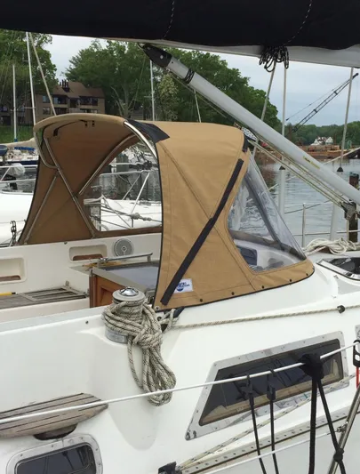 Dream Catcher Yacht Photos Pics 1995 Hylas 46 sailboat with tan canopy docked at marina.