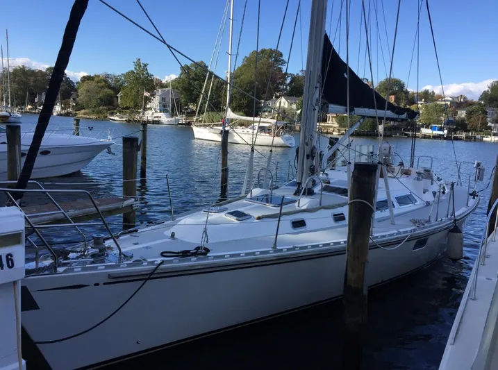Dream Catcher Yacht Photos Pics Sailboat docked in marina, Hylas 46 model, 1995, with clear blue sky.