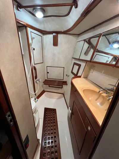 Dream Catcher Yacht Photos Pics Hylas 46 yacht bathroom, 1995 model, featuring wooden accents and compact design.