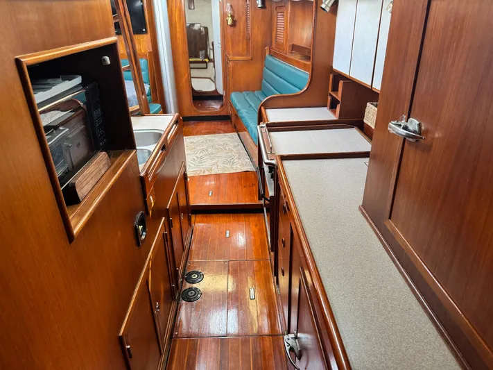 Dream Catcher Yacht Photos Pics Interior of a 1995 Hylas 46 yacht with wooden cabinetry and seating.