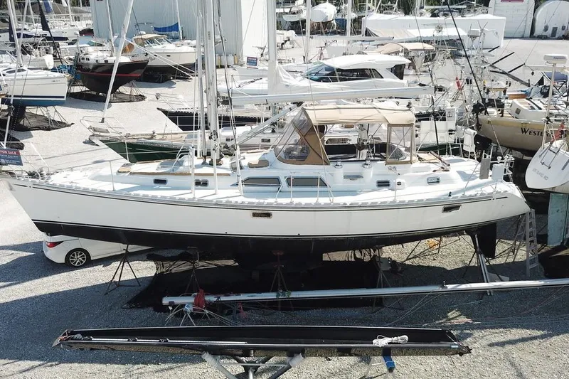 Dream Catcher Yacht Photos Pics Sailboat Hylas 46, 1995 model, on dry dock surrounded by other boats.