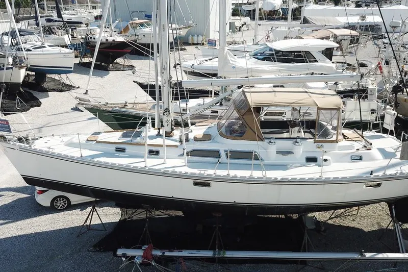 Dream Catcher Yacht Photos Pics Sailboat Hylas 46, 1995 model, docked in a marina with other boats.