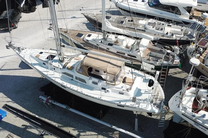 Dream Catcher Yacht Photos Pics Aerial view of a 1995 Hylas 46 sailboat in a marina, surrounded by other boats.