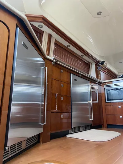  Yacht Photos Pics Luxurious kitchen interior of 2009 Sea Ray 58 Sedan Bridge yacht with stainless steel appliances.