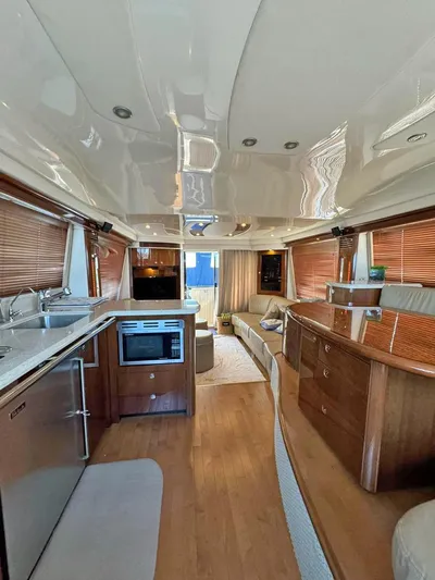  Yacht Photos Pics Luxurious interior of a 2009 Sea Ray 58 Sedan Bridge yacht with modern kitchen and seating area.