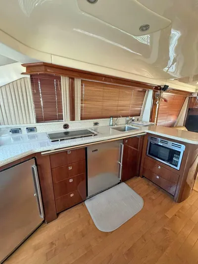  Yacht Photos Pics 2009 Sea Ray 58 Sedan Bridge yacht kitchen with modern appliances and wood cabinetry.