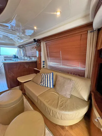 Yacht Photos Pics Luxurious interior of 2009 Sea Ray 58 Sedan Bridge yacht with leather seating and wooden accents.