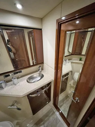  Yacht Photos Pics 2009 Sea Ray 58 Sedan Bridge yacht bathroom with modern fixtures and wood accents.