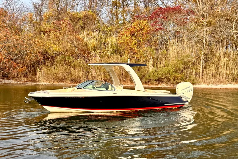  Yacht Photos Pics 2022 Chris-Craft Launch 25 GT boat on calm water with autumn foliage background.