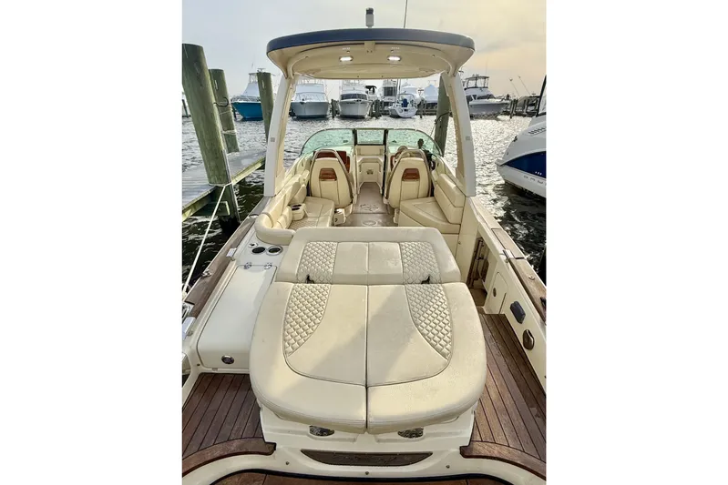  Yacht Photos Pics 2022 Chris-Craft Launch 25 GT boat interior with luxurious seating at a marina.