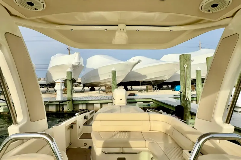  Yacht Photos Pics 2022 Chris-Craft Launch 25 GT interior view at marina with covered boats.