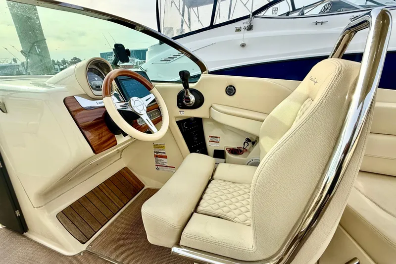  Yacht Photos Pics 2022 Chris-Craft Launch 25 GT interior with luxurious steering and seating.