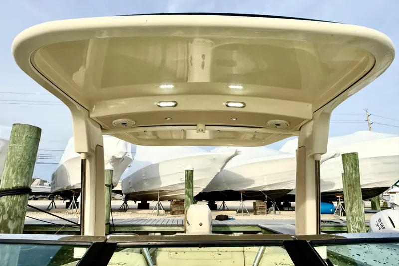  Yacht Photos Pics 2022 Chris-Craft Launch 25 GT boat with covered top, docked near wrapped boats.